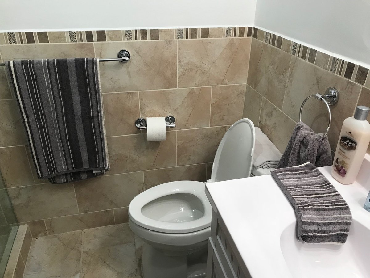 Newly installed toilet with clean silicone seal at the base